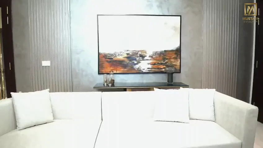 E52 living room with a cream sofa and contemporary artwork